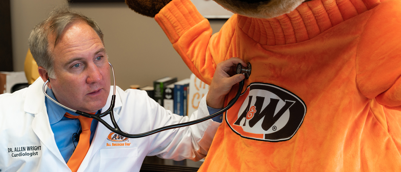 Dr. Allen Wright listening to Rooty's heart with a stethoscope